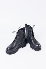 Women's black leather boots on a white background. Shoes and options for its layout. Autumn shoes. Boots. Autumn boots. Shoes close up