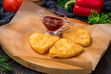 triangle fried Cheese sticks with berry sauce on the board