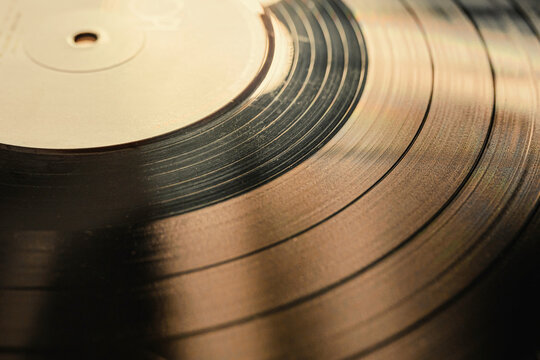 The texture of a vinyl record on a turntable. Photograph of a vinyl record with selective focus
