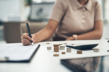 Fototapeta premium Working on her company's balance sheet. Closeup shot of an unrecognisable businesswoman calculating finances in an office.