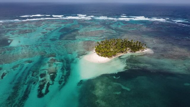 Aerial view of a desert island with a clear and transparent sea and a pristine beach in the archipelago of guna yala, Panama, San blas.