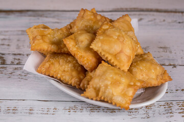Traditional pastry called pastel  in Brazil. Brazilian snack. Brazilian pastry.