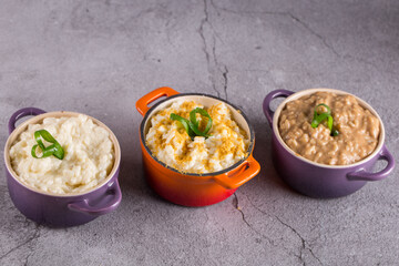 assorted risottos on gray background. Cheese risotto, funghi risotto and saffron risotto. Risotto festival concept