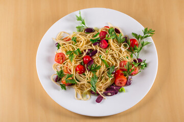 Spaghetti puttanesca.  spaghetti with black olives and cherry tomatoes. top view