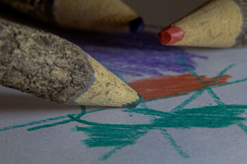 A wooden pencil draws on a white sheet. Close-up.