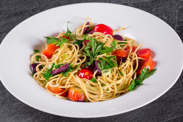 Spaghetti puttanesca.  spaghetti with black olives and cherry tomatoes.