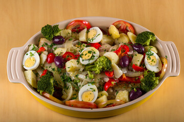 Cod - fish fillet with sauce and vegetables..A typical Portuguese dish with cod called Bacalhau a Portuguesa