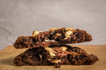 close up view of stack of the cut in half chocolate cookies with macadamia nuts and chocolate chips...