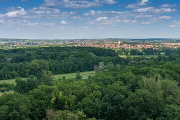 Fototapeta na wymiar Lednice-Valtice complex, view from Minaret-observation tower for park with trees, on background town Podivin