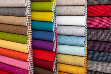 Colorful textile palette. Texture background. Multicolor upholstery fabric samples close-up shallow depth of field. Color selection