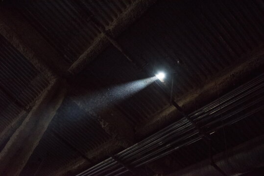 Beam Of Light From A Small Pinhole Hole In An Abandoned Building. Particulates Dust