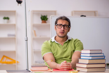 Young sick male teacher student in blood transfusion concept