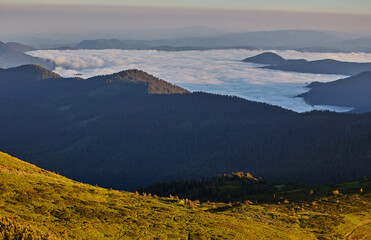 Amazing mountain landscape with colorful vivid sunset on the cloudy sky, natural outdoor travel background.