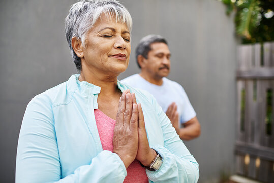 Enhance Your Mind With Meditation. Shot Of An Older Couple Meditating Together Outdoors.