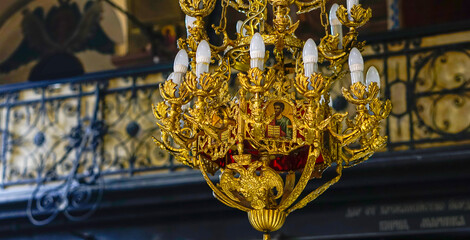 A golden chandelier hanging from the ceiling in the church