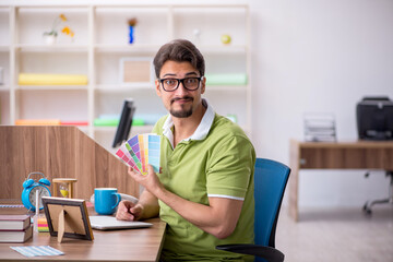 Young male designer working in the office