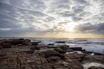 Fototapeta na wymiar View of the ocean with rocks and morning clouds in South Africa