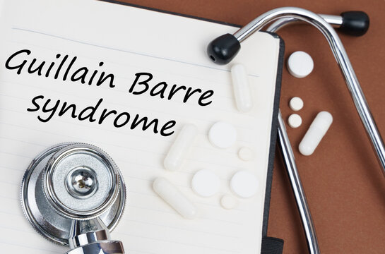 On A Brown Surface Lie Pills, A Stethoscope And A Notebook With The Inscription - Guillain Barre Syndrome