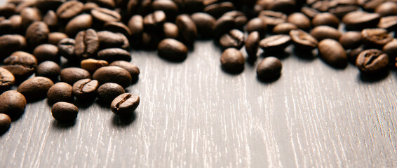 roasted coffee beans on a wooden background close up