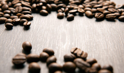 roasted coffee beans on a wooden background close up