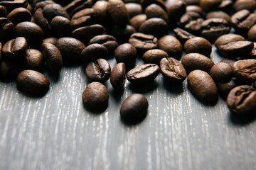 roasted coffee beans on a wooden background close up