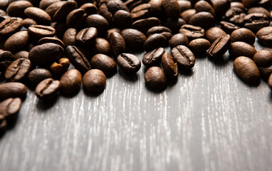 roasted coffee beans on a wooden background close up