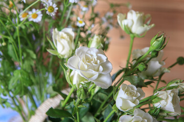 Bouquet of spray white rose on a canvas tablecloth on the table