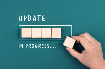 The words update in progress are standing beside the loading bar, hand puts last cube to the...
