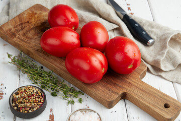 Fresh red tomatoes, close-up of fresh, ripe tomatoes on wooden background