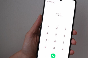 Woman calling 112 for an emergency. It says 
