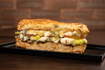 Sandwich with mozzarella cheese, gorgonzola cheese, tomato and lettuce