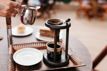 Female hand serving freshly brewed coffee