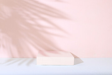 Abstract background with natural wooden podiums and long shadows on a pink wall, an empty showcase...