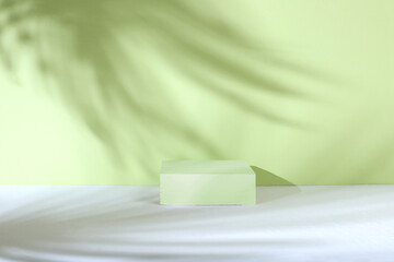 Abstract background with natural wooden podiums and long shadows on a green wall, an empty showcase...