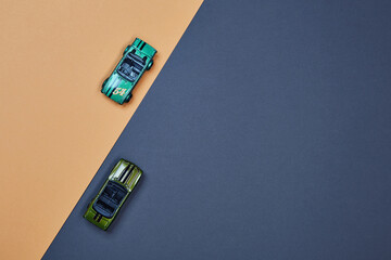 Two micro toy small mini cars opposite direction top view percent sign style composition isolated...
