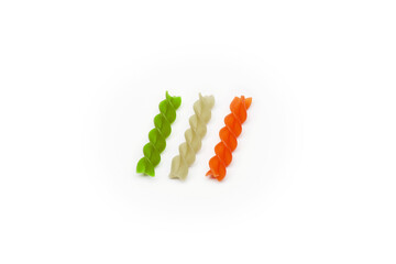 Colored raw uncooked italian three separate pieces of fusilli pasta composed as flag of italy isolated on the bright solid fond plain white clean background