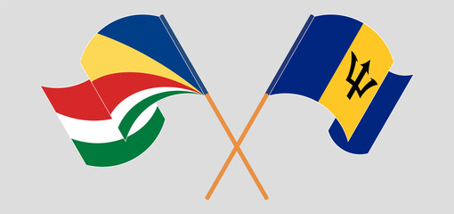 Crossed and waving flags of Seychelles and Barbados