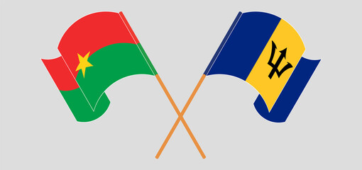 Crossed and waving flags of Burkina Faso and Barbados