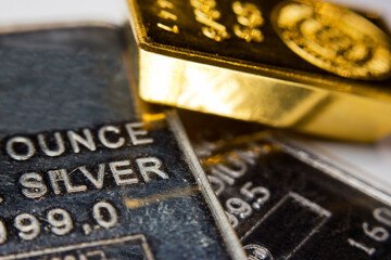 Close-up of a gold ingot on top of a troy ounce silver and palladium bar - 482483569