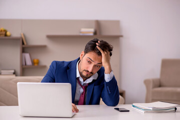 Young businessman working from house