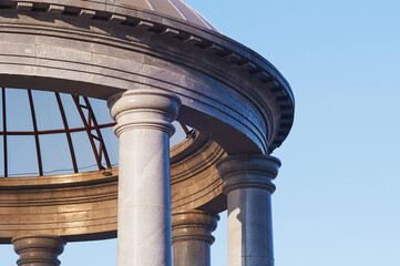 Dome of a marble rotunda made of transparent glass. Sunlight at dawn. Details of architecture on...