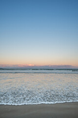 Fototapeta premium Beach Sunset Over the Waves at Orewa, Auckland New Zealand