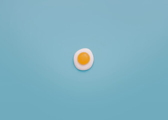 Egg. Top view photo in minimal style. Small omelet on light blue background. Design template with copy space