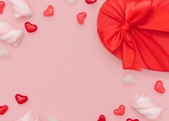 Romantic gift. Top view photo with copy space. Colorful sweet food and desserts with gift box in heart shape