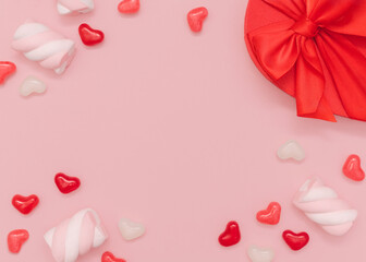 Valentine's day. Photo template with copy space. Candies and marshmallow with gift box in heart shape