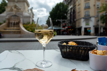Drinking of brut champagne sparkling wine in street cafe in old central part of city Reims, Champagne, France