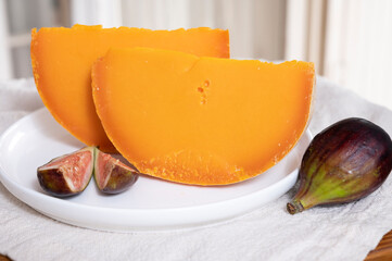 Cheese collection, French cheese mimolette made from cow milk served with fresh figs