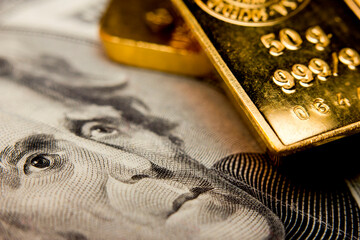 Close-up of a 20-dollar US banknote and gold bullions