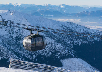 gondola ski lift in mountain ski resort, winter day, snowy spruce forest - obrazy, fototapety, plakaty