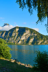 Fishing by the lake Mondsee in Alps mountains, Austria. Beautiful sunset landscape. 